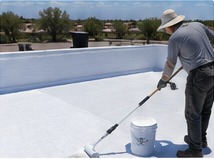 White roof coating being applied